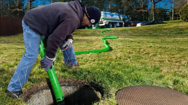 Service technician performing residential septic pumping and drainage maintenance in ,